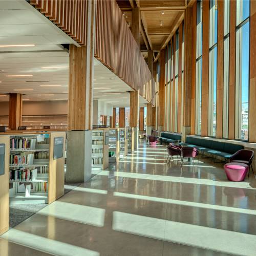 Interior of the new East County Library with books and a seating area, links to information about library construction.