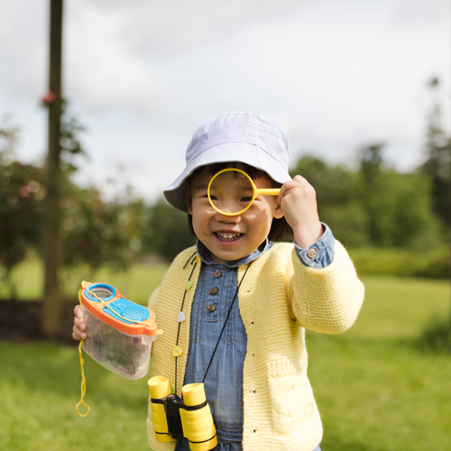 Toddler girl playing in spring park, links to information about activities for spring.
