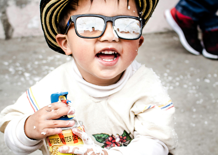 Boy wearing hat and glasses.